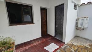 a room with a door and a television on a wall at La Merced in Salta