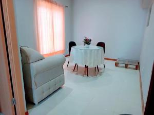 a living room with a table and a couch and a chair at Apartamento T1 in Praia