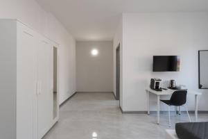 a white room with a table and a chair at Travelershome Ciampino Airport GuestHouse 600m to Airport in Ciampino