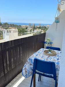 a table and chairs on a balcony with a view at MAREA Algarve - Sea view sunny apartment in Alvor in Alvor