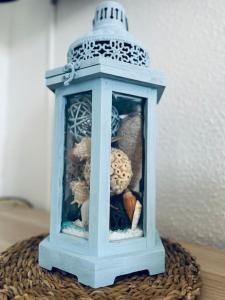 a small blue lantern with stuffed animals in it at MAREA Algarve - Sea view sunny apartment in Alvor in Alvor