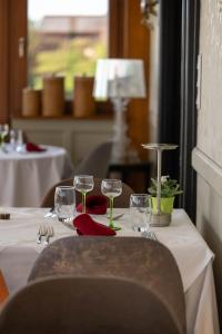 uma mesa com copos de vinho num restaurante em Hotel Restaurant Au Riesling em Zellenberg