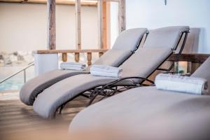 a couple of chairs sitting on a balcony at Hotel Wieser in Campo di Trens