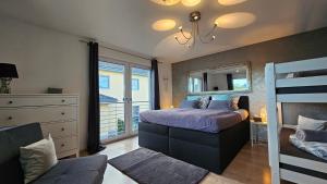 a bedroom with a bed and a dresser and a mirror at Gästehaus Ferienwohnung Abendstern in Rust