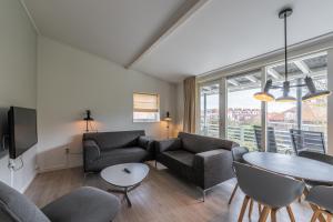 salon z kanapą i stołem w obiekcie Zeayou Zeeland - Appartementen Beatrixstraat 29 w mieście Domburg