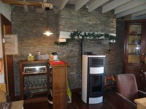 a kitchen with a refrigerator and a counter in a room at B&B Le bruissement in Bièvre