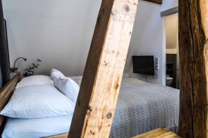 a bedroom with a bed with a tall wooden ladder at Besighomes Apartment Loft in Besigheim