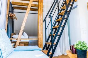 a room with a bunk bed and a ladder at Besighomes Apartment Loft in Besigheim