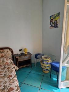 a bedroom with a bed and a desk and a table at Agriturismo Fuoco D'Amalfi Villa Iazzetta in Amalfi