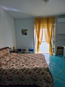 a bedroom with a bed and a large window at Agriturismo Fuoco D'Amalfi Villa Iazzetta in Amalfi