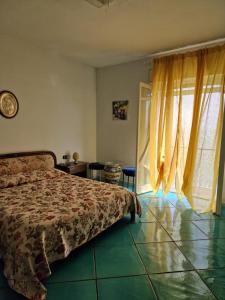 a bedroom with a bed and a window at Agriturismo Fuoco D'Amalfi Villa Iazzetta in Amalfi