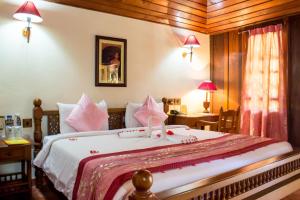 A bed or beds in a room at Isola Di Cocco Ayurvedic Beach Resort