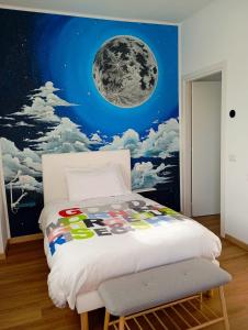 a bedroom with a moon mural on the wall at Sleep & Fly Villa Luisa in Case Nuove