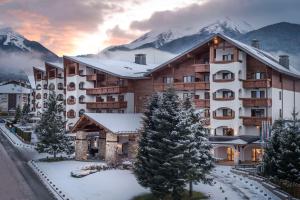 ein Hotel in den Bergen mit Schnee auf dem Boden in der Unterkunft Kempinski Hotel Grand Arena Bansko in Bansko