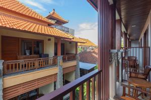 a balcony of a house with a table and chairs at Donahome in Sanur