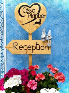 a sign for a csa planter and a bouquet of flowers at Cesa Planber Apartments Mountain View SKI-IN SKI-OUT in Canazei