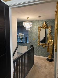 a staircase with a mirror and a chandelier at Stunning 2 bedroom apartment in Preston