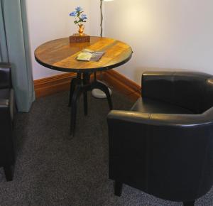 une table et deux chaises dans une pièce dans l'établissement Artica Art & Accommodation, à Dunedin