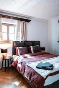 a bedroom with a large bed with a window at Hotel Sonnenalm Stuhleck in Spital am Semmering