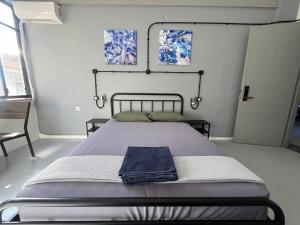 Un dormitorio con una cama con una toalla azul. en Urban Rooms, en Atenas