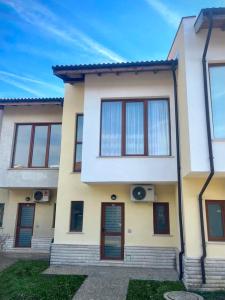 a white house with windows and a door at Luxury Lighthouse Golf Villa in Balchik