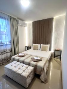 a hotel room with two beds and a large window at Luxury Lighthouse Golf Villa in Balchik