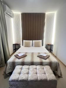 a bedroom with a large bed with two pillows at Luxury Lighthouse Golf Villa in Balchik