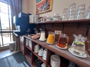 a kitchen with a shelf filled with different types of food at Memel Hotel in Klaipėda