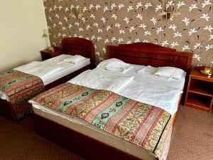 Cama ou camas em um quarto em Hotel Erzsébet