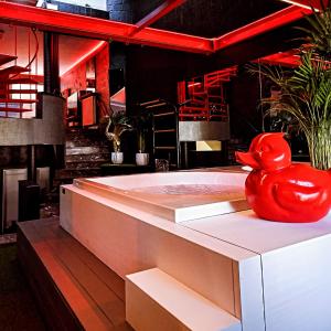 a bath tub with a red rubber duck sitting on it at cosy corner waterloo in Waterloo