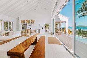 una sala de estar de planta abierta y una cocina con vistas al océano. en Long Bay Beach Resort, en Tortola Island