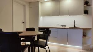 a kitchen with a table and chairs and cabinets at G-47 Near the Parliament in Vilnius