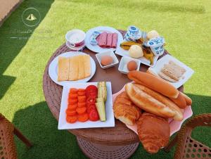 einen Tisch mit Käse, Gemüse und Brot in der Unterkunft Sidi Hamad Pyramids View in Kairo