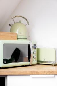 a toaster oven sitting on top of a counter at Suite & SPA à La Ferme 1802 in Sainghin-en-Mélantois