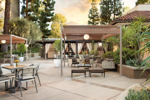 a patio with tables and chairs in a restaurant at The Garland in Los Angeles