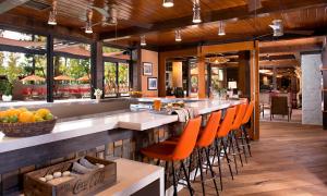 a bar with orange chairs at a restaurant at The Garland in Los Angeles