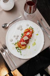 a white plate with a piece of food on a table at briig boutique hotel in Split