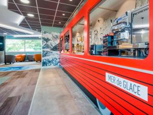 a fast food restaurant with a red train at Ibis Styles Sallanches Pays du Mont-Blanc in Sallanches