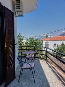 a balcony with a chair and a table on it at ΛΕΥΚΙΑΣ. in Pirgos Dhirou