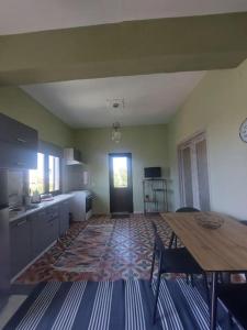 a kitchen with a wooden table and a dining room at ΛΕΥΚΙΑΣ. in Pirgos Dhirou