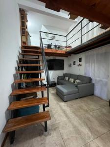 a spiral staircase in a living room with a couch at Dpto. Excelente acceso, cercano a estadio. in Ciudadela