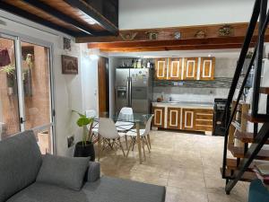 a kitchen with a table and a stainless steel refrigerator at Dpto. Excelente acceso, cercano a estadio. in Ciudadela