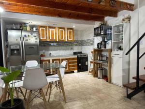 a kitchen with a table and chairs in it at Dpto. Excelente acceso, cercano a estadio. in Ciudadela