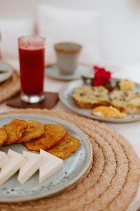 a table with two plates of food and a drink at Amarla Boutique Hotel Cartagena in Cartagena de Indias