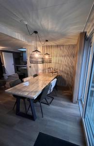 a dining room table with chairs and a light fixture at 4 tot 8 persoons huisje - Veluwemeer - Biddinghuizen - Harderwijk - Elburg in Biddinghuizen