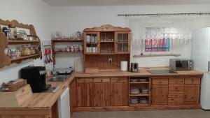 a kitchen with wooden cabinets and a counter top at Dworek pod świerkami in Jelenia Góra