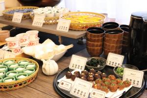 a table topped with bowls and plates of food at KOKO HOTEL Nagoya Sakae in Nagoya