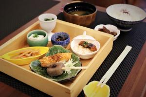 a wooden tray filled with food on a table at KOKO HOTEL Nagoya Sakae in Nagoya