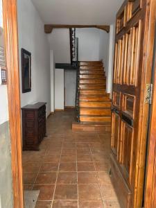 a hallway with a staircase and a door and a room at calle mayor in Alcalá de Henares