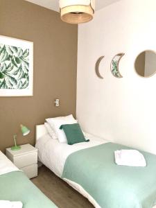 a bedroom with two beds and a crescent moon on the wall at Beau T3 lumineux : La Couronne in Rochefort